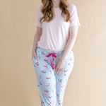 Woman wearing a light pink t-shirt and blue pajama pants with Mahjong pattern on a beige background ::: Model is 5'7" wearing size M ///