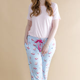 Woman wearing a light pink t-shirt and blue pajama pants with Mahjong pattern on a beige background ::: Model is 5'7" wearing size M ///