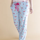 Light blue pajama pants with pink bow and Mahjong pattern on a beige background