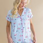 Woman wearing a light blue pajama set with pink and red Mahjong print on a beige background ::: Model is 5'9" wearing size S ///