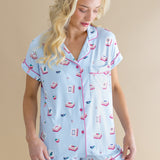 Woman wearing a light blue pajama set with pink and red Mahjong print on a beige background ::: Model is 5'9" wearing size S ///