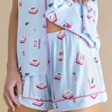 Light blue pajama set with pink trim featuring Mahjong designs on a beige background