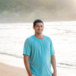 Smiling male model wearing the Men's Crew Neck Tee in Makai