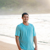 Smiling male model wearing the Men's Crew Neck Tee in Makai