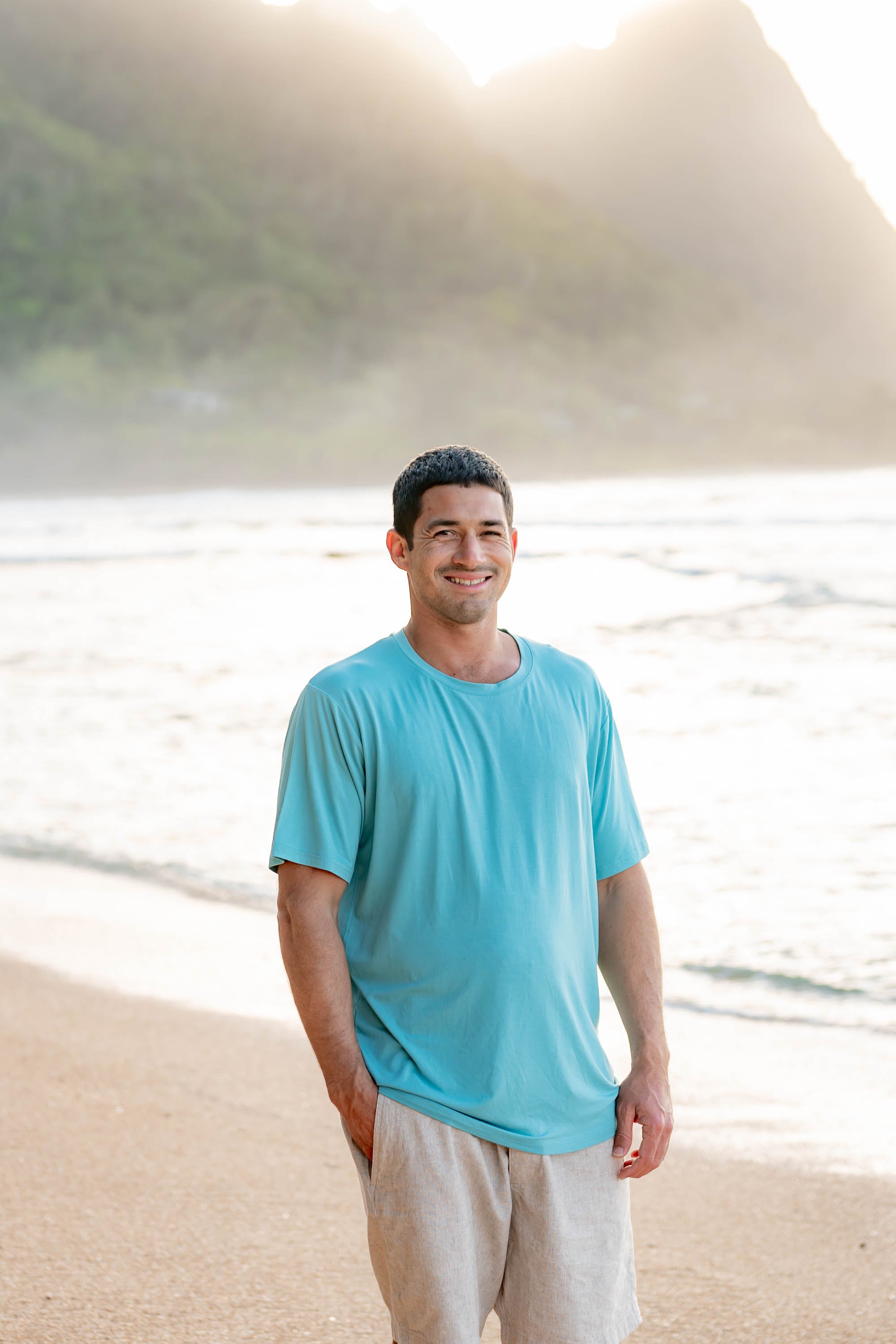Smiling male model wearing the Men's Crew Neck Tee in Makai