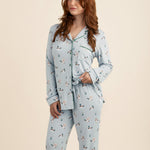 Woman wearing a light blue pajama set with duck pattern on a beige background