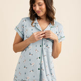 Woman wearing a light blue pajama set with duck print on a beige background ::: Model is 5'5" wearing size S ///