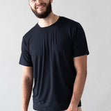 Male model wearing the Men's Crew Neck Tee in Midnight with Khaki colored pants