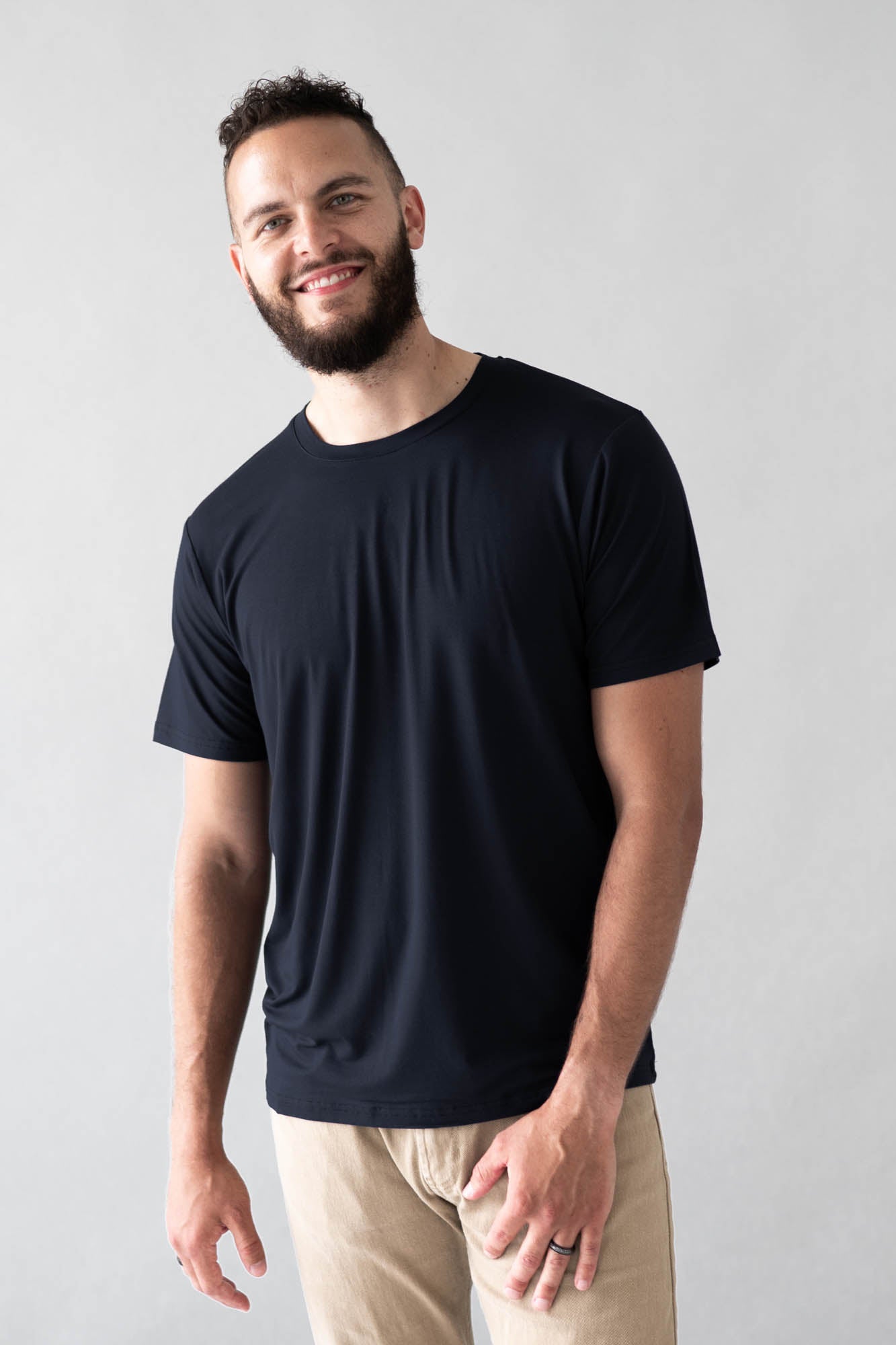 Male model wearing the Men's Crew Neck Tee in Midnight with Khaki colored pants