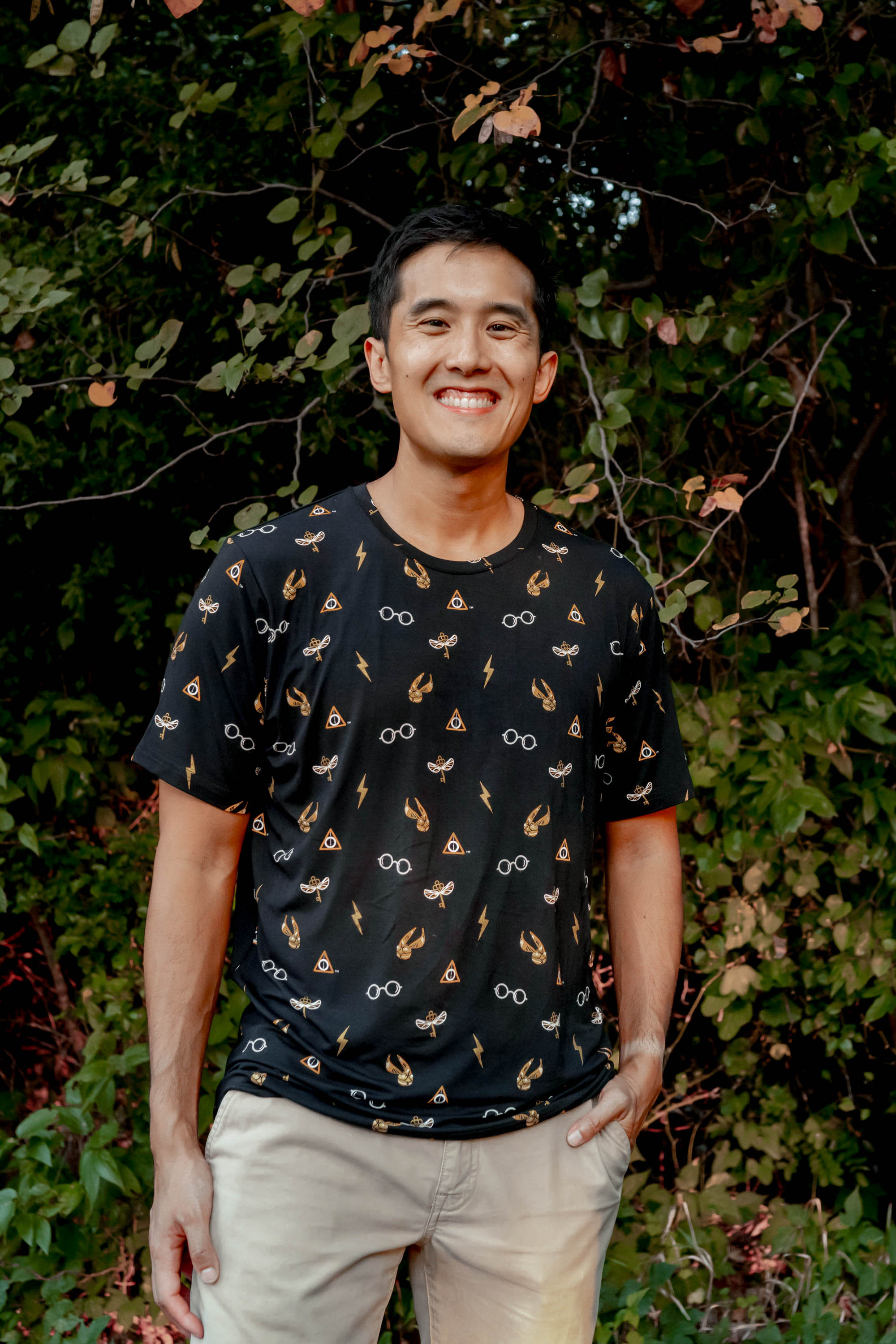 Smiling model wearing the Men's Crew Neck Tee in Midnight Icon with khaki colored pants