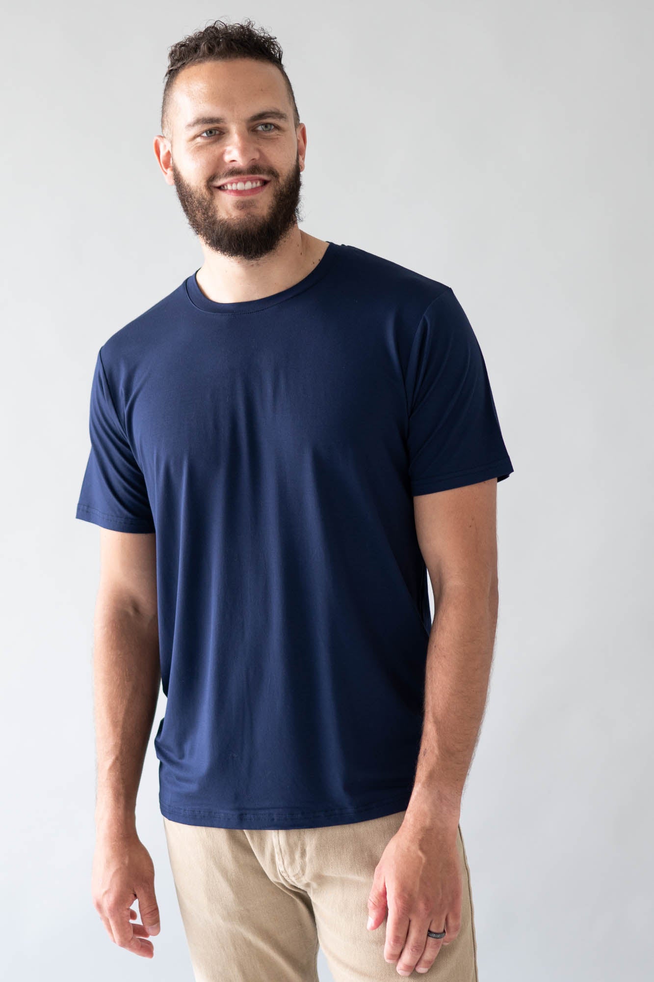 Male model wearing the Men's Crew Neck Tee in Navy with khaki colored pants