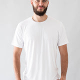 Male model wearing the Men's Crew Neck Tee in Snow with light wash jeans