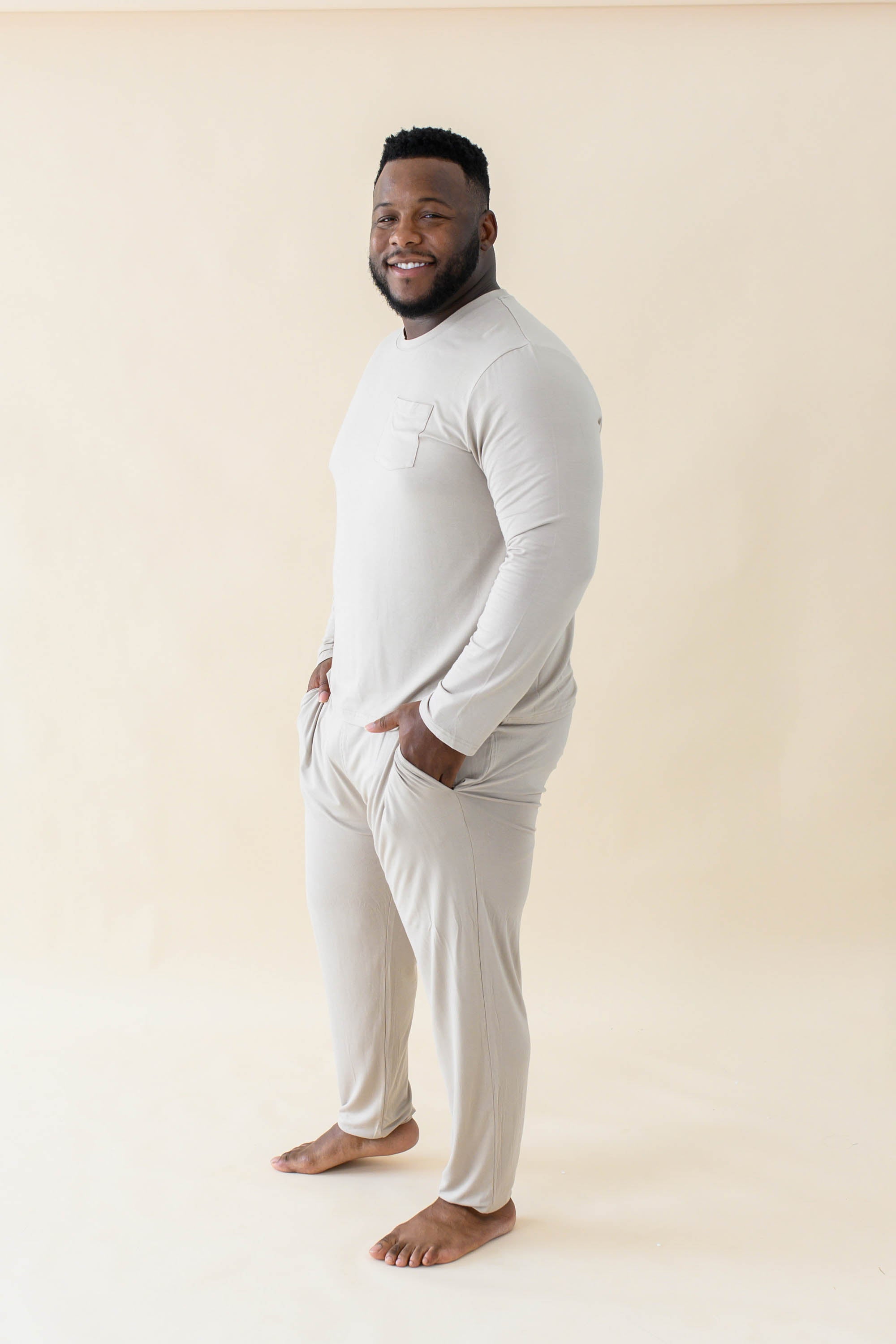 Smiling male model wearing the Men's Jogger Set in Almond with both hands in pants pockets