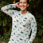 Smiling male model wearing the Men's Jogger Set in Journey with one hand in the pants pocket and one hand up and behind his head