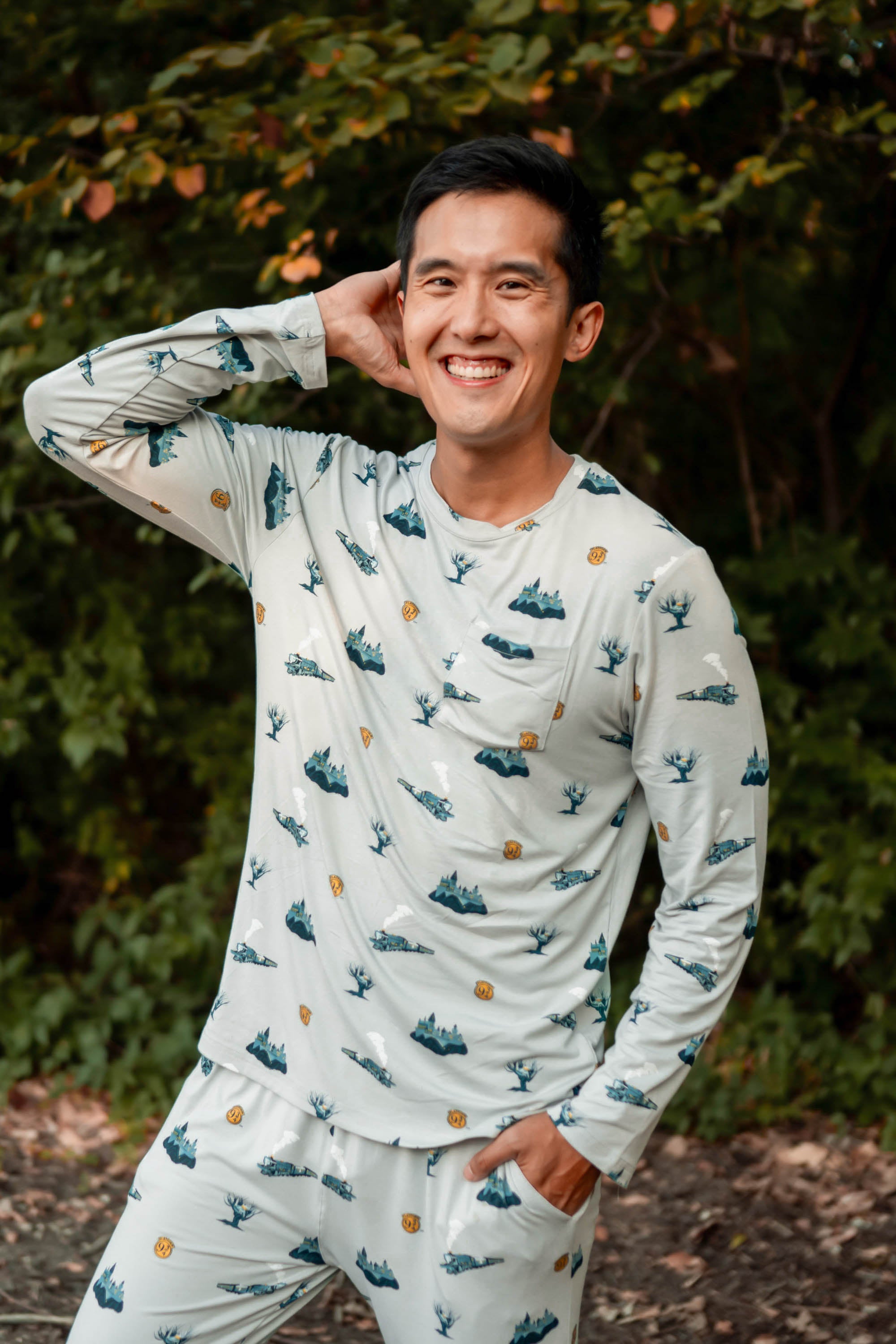 Smiling male model wearing the Men's Jogger Set in Journey with one hand in the pants pocket and one hand up and behind his head