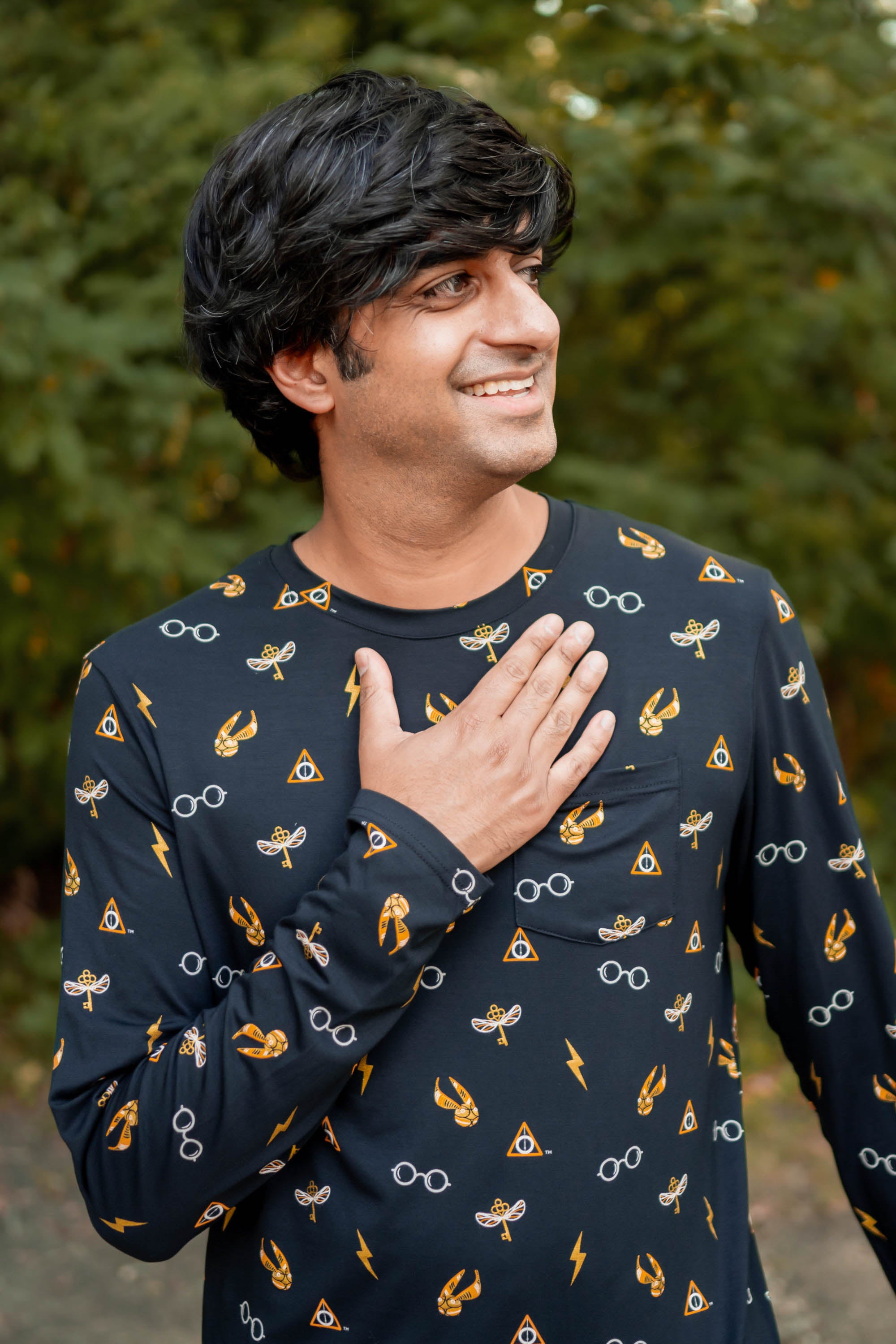 Smiling model wearing the Men's Jogger Set in Midnight Icon with one hand on his chest