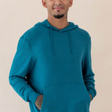 Male wearing the Men's Ribbed Hoodie in Loch with his hands in the front pocket