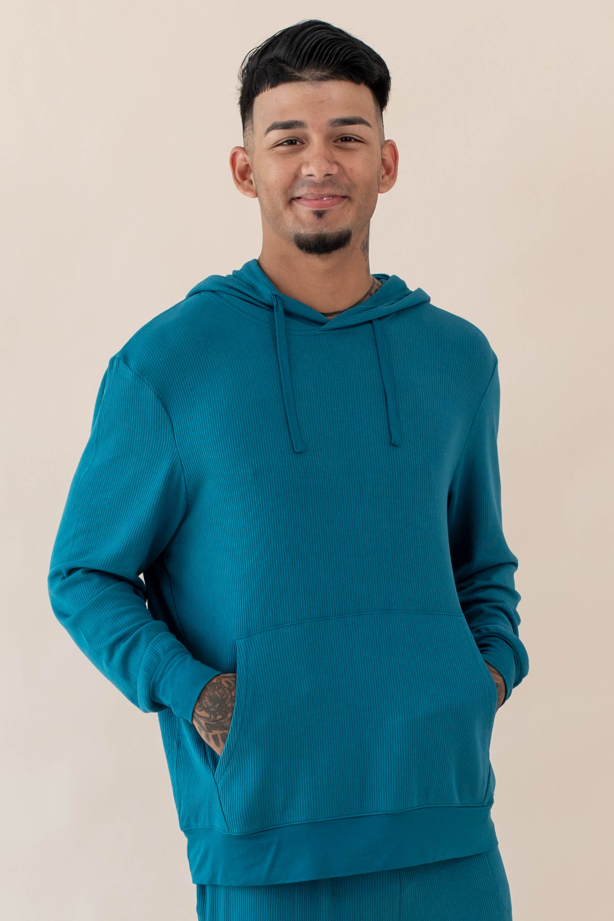 Male wearing the Men's Ribbed Hoodie in Loch with his hands in the front pocket