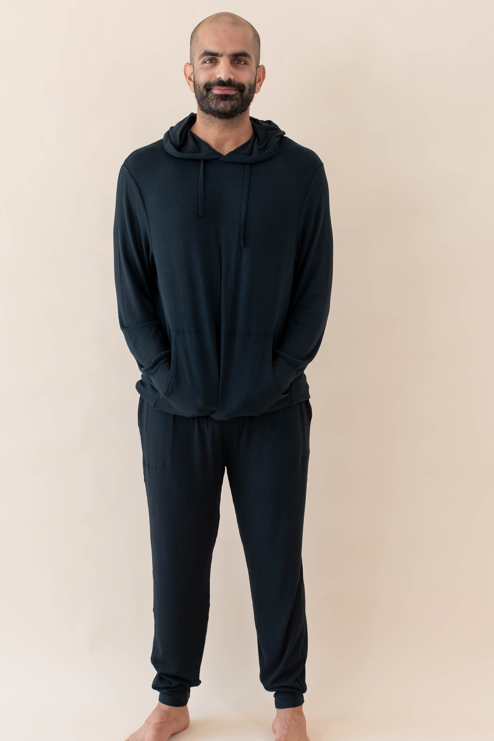Male model wearing the Men's Ribbed Jogger Pant in Midnight and Ribbed Hoodie in Midnight 