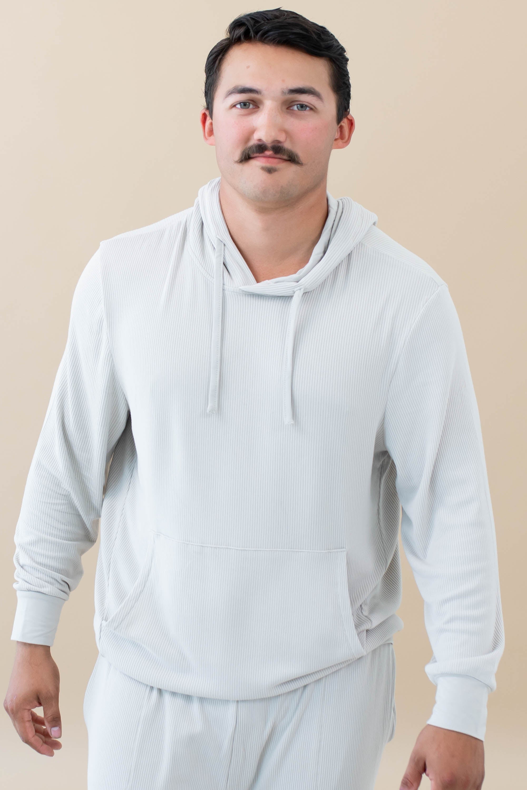 Male model wearing the Men's Ribbed Hoodie in Oat