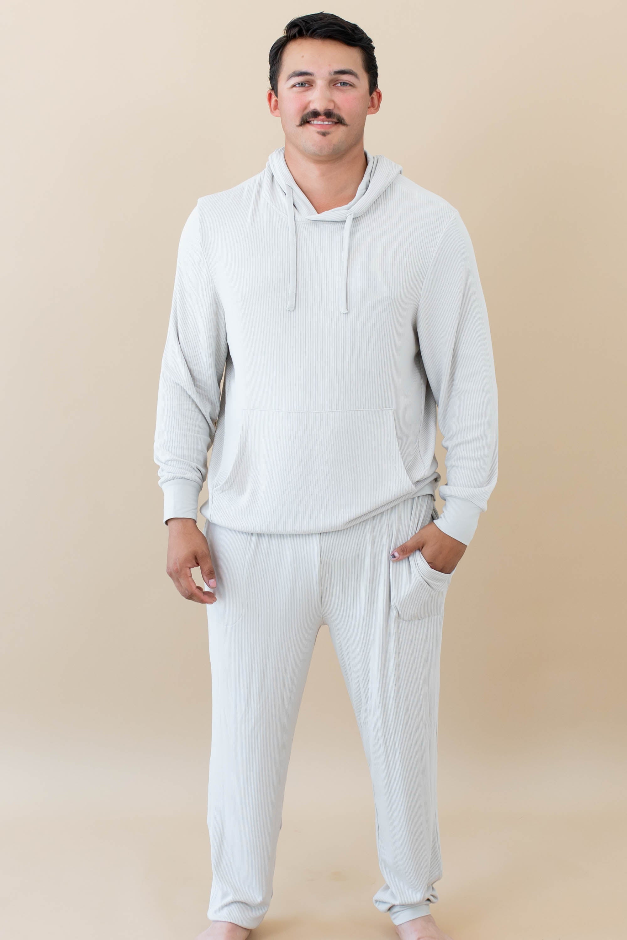 Male model wearing the Men's Ribbed Jogger Pant in Oat and Men's Ribbed Hoodie in Oat