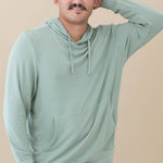 Male model wearing the Men's Ribbed Hoodie in Thyme with one arm up and behind his head