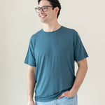 Model standing with hand in pocket while wearing the Men's Crew Neck Tee in Atlantic