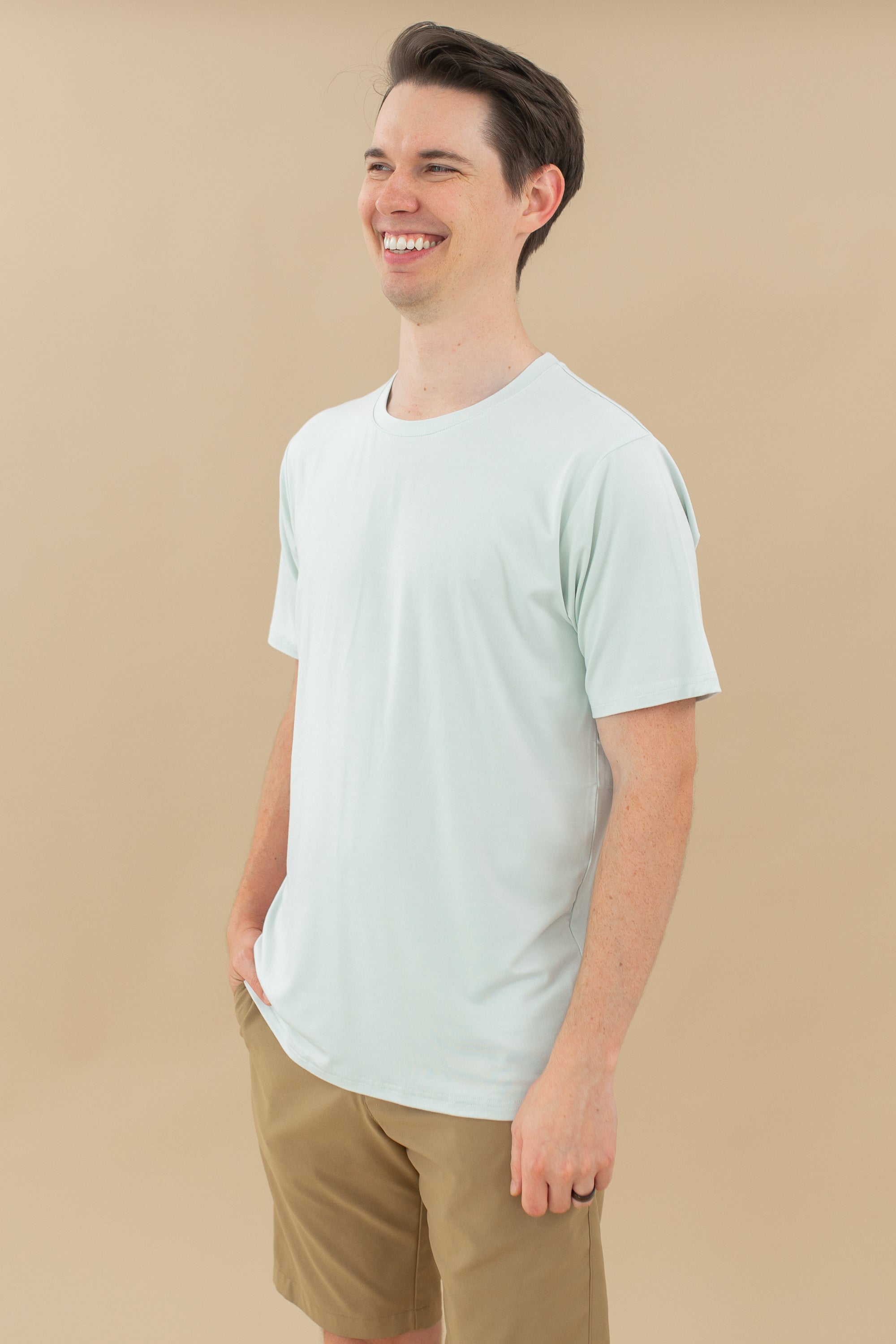 Man modeling Men's Crew Neck Tee in Dew with hand in shorts pocket