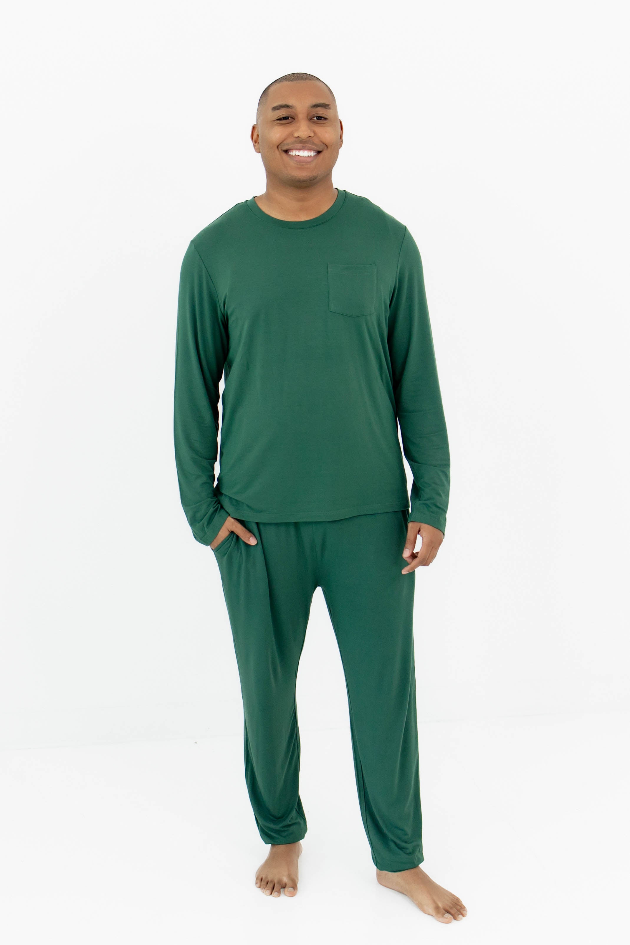 Smiling male model wearing the Men's Jogger Set in Evergreen with one hand in the pants pocket