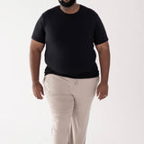 Male model walking in Men's Crew Neck Tee in Midnight and Men's Oat Lounge Pants