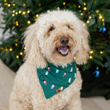 Medium sized dog wearing the Dog Bandana in Merry and Bright standing in front of a decorated Christmas tree