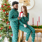 Couple wearing matching  Jogger Sets in  Merry and Bright in front of a Christmas tree