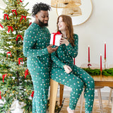 Couple wearing matching  Jogger Sets in  Merry and Bright in front of a Christmas tree