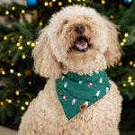 Medium sized dog wearing the Dog Bandana in Merry and Bright standing in front of a decorated Christmas tree