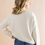 Model showcasing the back side of the Women's Sweatshirt in Mickey and Friends on Ecru