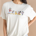 Close up of the Women's Graphic Tee in Mickey and Friends on Ecru  on a model paired with jean shorts