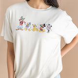 Close up of the Women's Graphic Tee in Mickey and Friends on Ecru  on a model paired with jean shorts