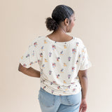 Back of the model wearing the Women's Relaxed Fit V-Neck in Mickey Mouse and Friends