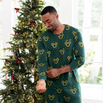 Man standing in front of decorated Christmas tree wearing Men's Jogger Set in Mickey Christmas Wreath print