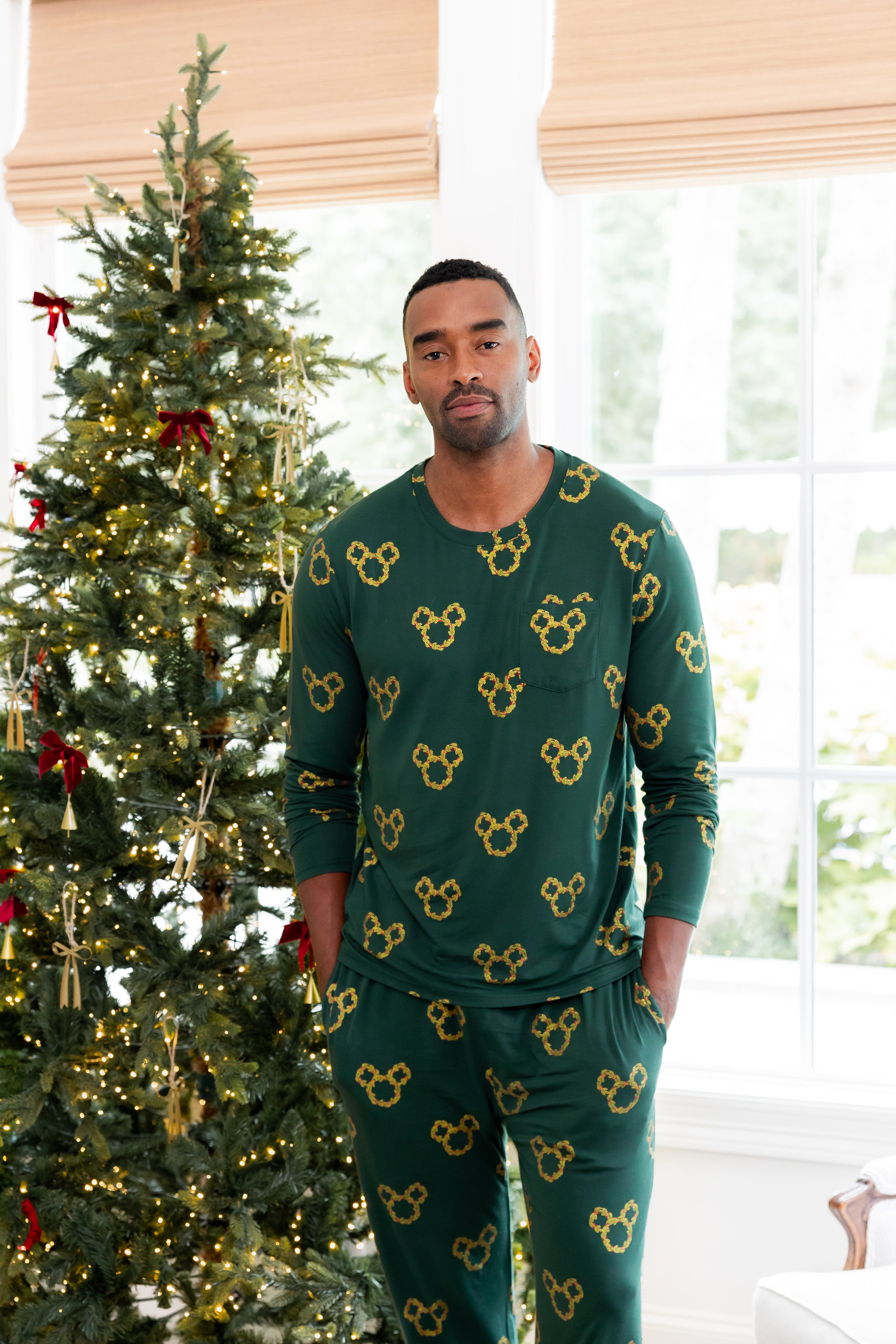 Man standing in front of decorated Christmas tree wearing Men's Jogger Set in Mickey Christmas Wreath print
::: Model is 6'2" wearing size L ///
