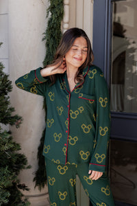 Woman wearing Long-Sleeved Women's Pajama Set in Mickey Christmas Wreath print smiling outdoors