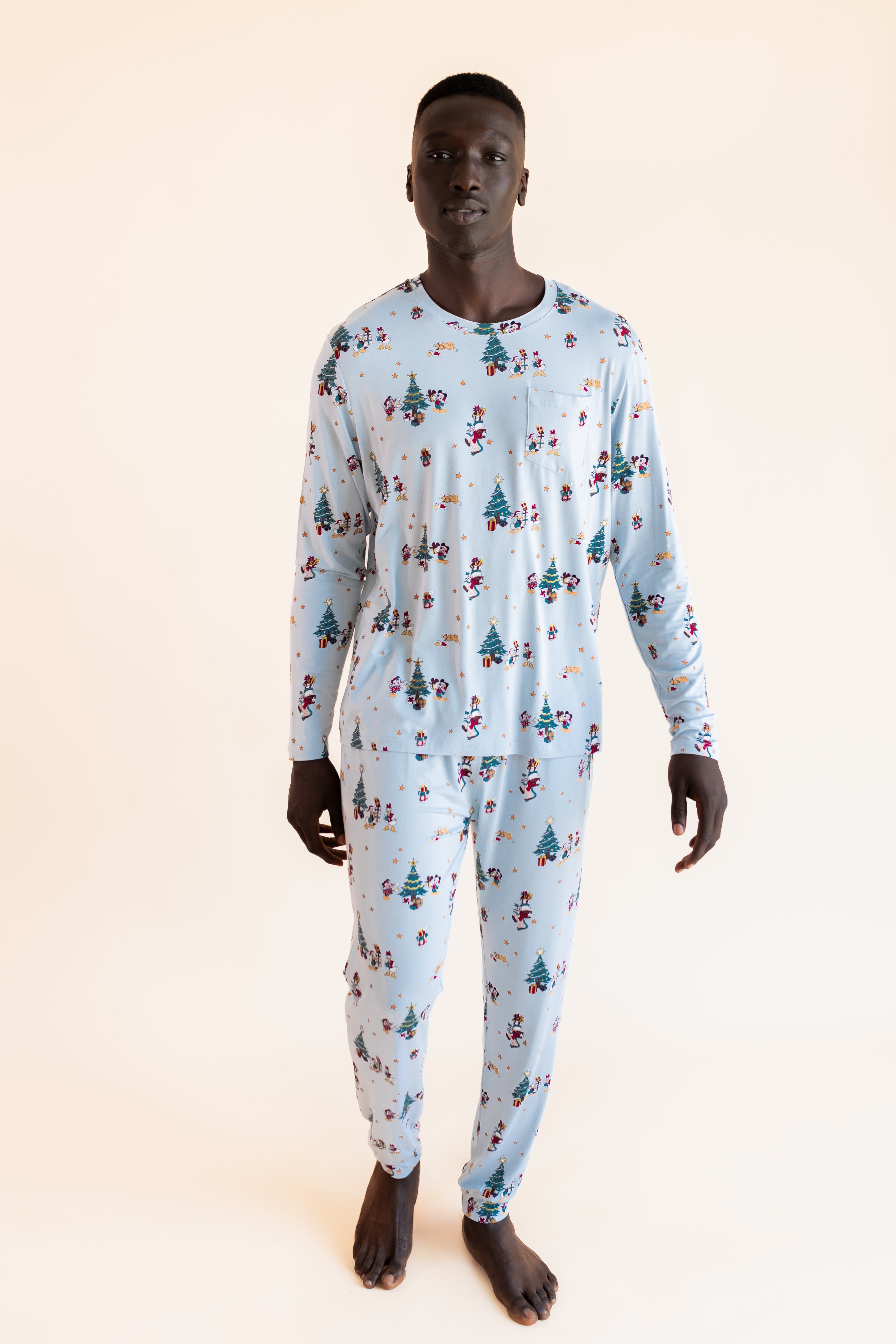 Man wearing Men's Jogger Set in Mickey & Friends Christmas print on a beige background
::: Model is 6'1" wearing size L ///