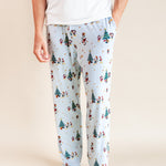 Modal wearing Men's Lounge Pants in Mickey & Friends Christmas print on a beige background
::: Model is 6'3" wearing size L ///