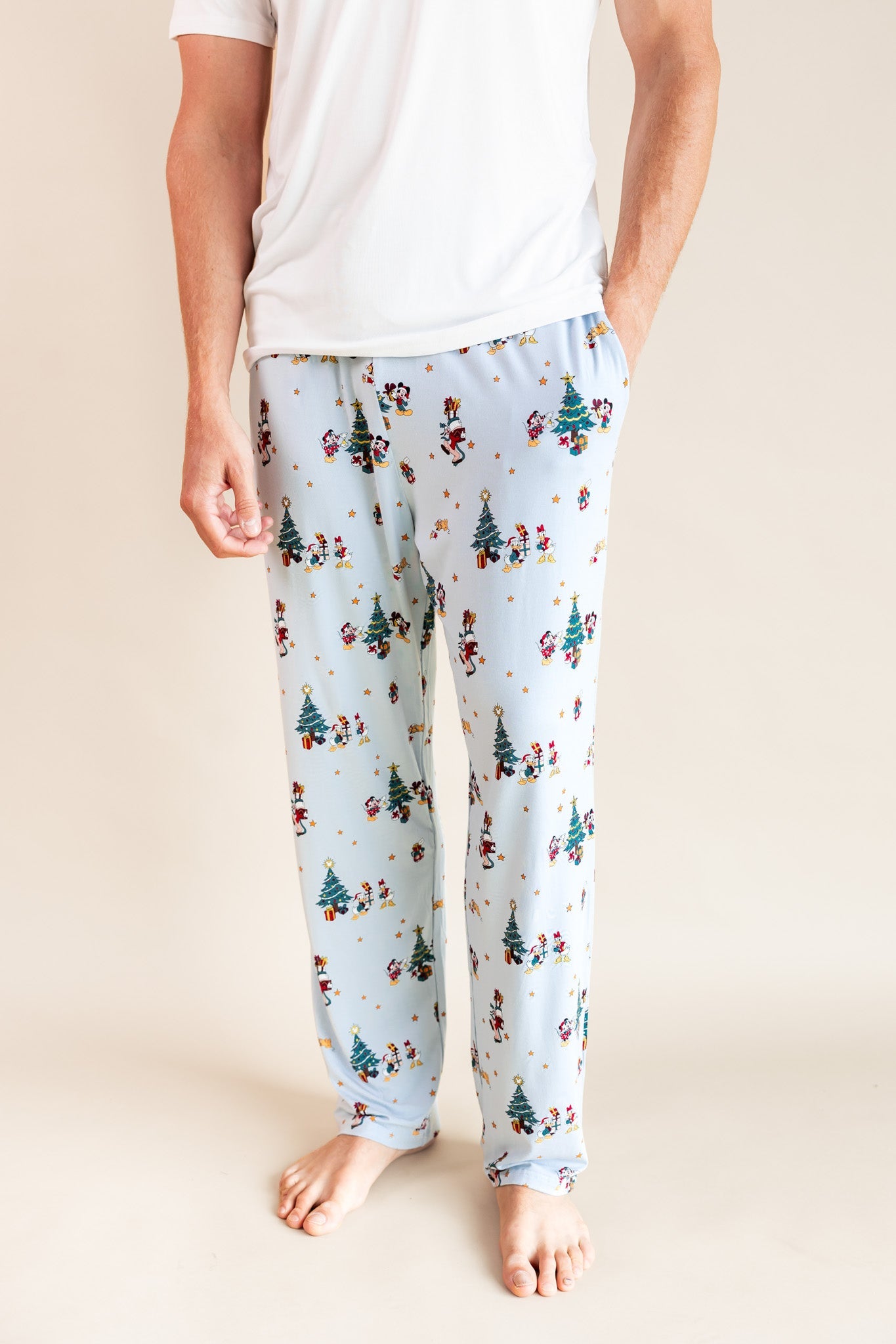 Modal wearing Men's Lounge Pants in Mickey & Friends Christmas print on a beige background
::: Model is 6'3" wearing size L ///