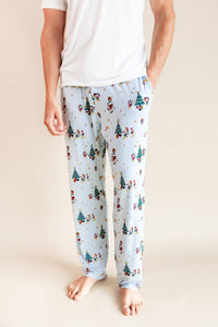 Modal wearing Men's Lounge Pants in Mickey & Friends Christmas print on a beige background
