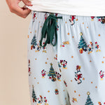Modal showcasing green drawstring on Men's Lounge Pants in Mickey & Friends Christmas print over white T-shirt on a beige background