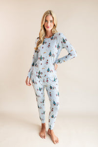 Woman wearing Women's Jogger Pajama Set in Mickey & Friends Christmas print on a beige background