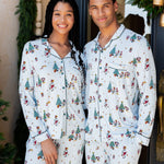 couple wearing matching christmas mickey and friends pajamas