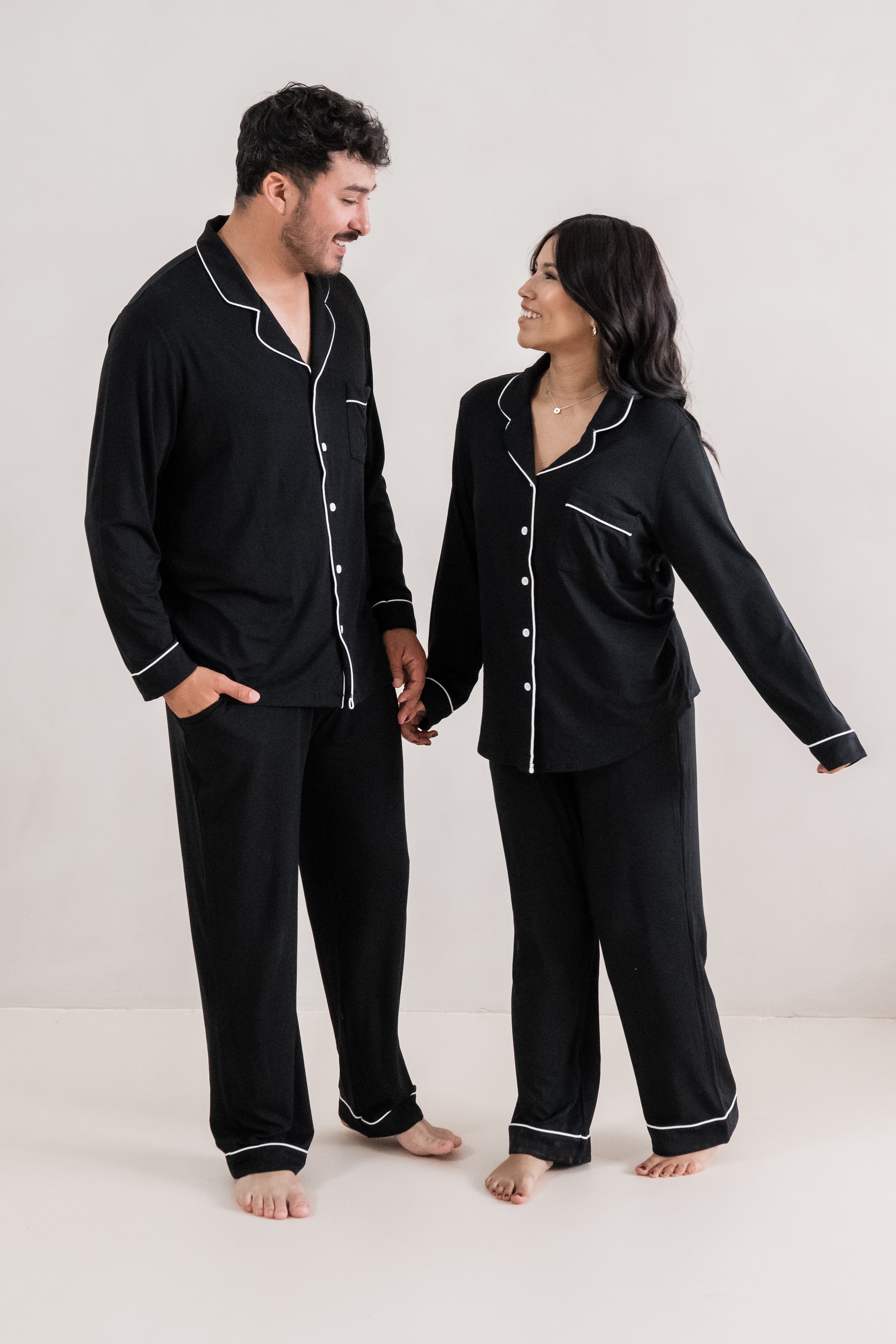 Couple holding hands wearing matching  Long Sleeve Pajama Sets in Midnight