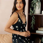 Model posing in Women's Nightgown in Big Midnight Magnolia print sitting on beige sofa side